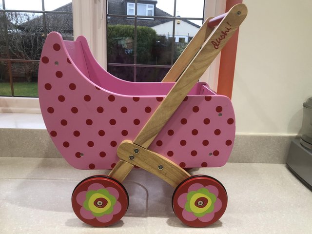 Preview of the first image of Child’s toy pink sturdy wooden pram.