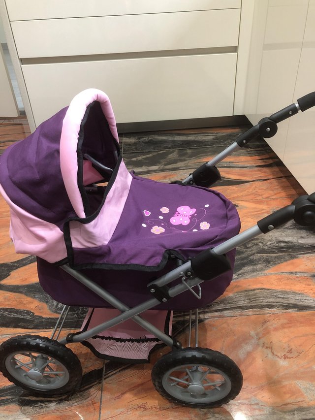 Preview of the first image of Child’s folding toy pram in purple.