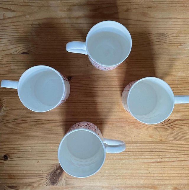 Preview of the first image of SET OF 4 VINTAGE MATCHING BONE CHINA MUGS.