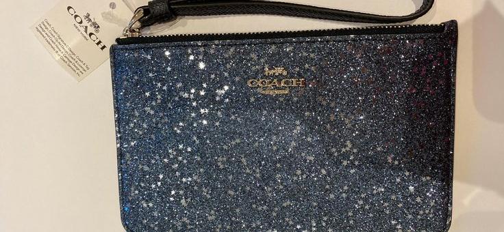 Preview of the first image of Coach blue glitter wristlet bag.